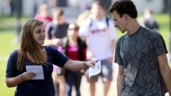 Genna Schwartz of the Ohio State University Student Democrats hands out information about President Obama's upcoming visit to the school