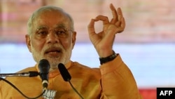 FILE - Indian Prime Minister and Bharatiya Janata Party leader Narendra Modi gestures as he speaks during a public rally ahead of the Maharashtra state election in Mumbai, October 2014.