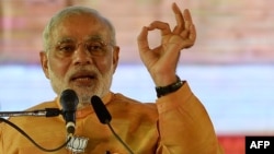 Indian Prime Minister and Bharatiya Janata Party leader Narendra Modi gestures as he speaks during a public rally ahead of the Maharashtra state election in Mumbai, Oct, 4, 2014. 