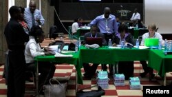 Election clerks go through the re-tallying of votes after the Kenya Supreme Court issued an order in the ongoing presidential poll petition in Kenya's capital Nairobi March 26, 2013.