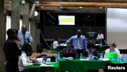 FILE - Election clerks go through the retallying of votes after the Kenya Supreme Court issued an order related to a presidential poll petition in Kenya's capital, Nairobi, March 26, 2013.