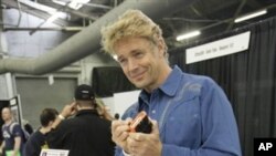 John Schneider, from "The Dukes of Hazzard," autographs a replica of the show's "General Lee" car at the Big Apple Comic Con in New York in 2009