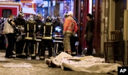 Rescue workers gather in the 10th district of Paris, Nov. 13, 2015. 130 people were killed in a series of unprecedented attacks around Paris.