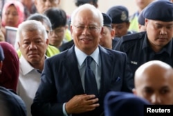 FILE - Malaysia's former Prime Minister Najib Razak arrives in court in Kuala Lumpur, Malaysia, Oct. 4, 2018.