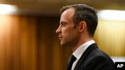 FILE - Oscar Pistorius pauses in the dock at the High Court in Pretoria, South Africa, Dec. 8, 2015. The denial of his appeal clears the way for a judge to sentence Pistorius on his murder conviction at a hearing set for April 18.