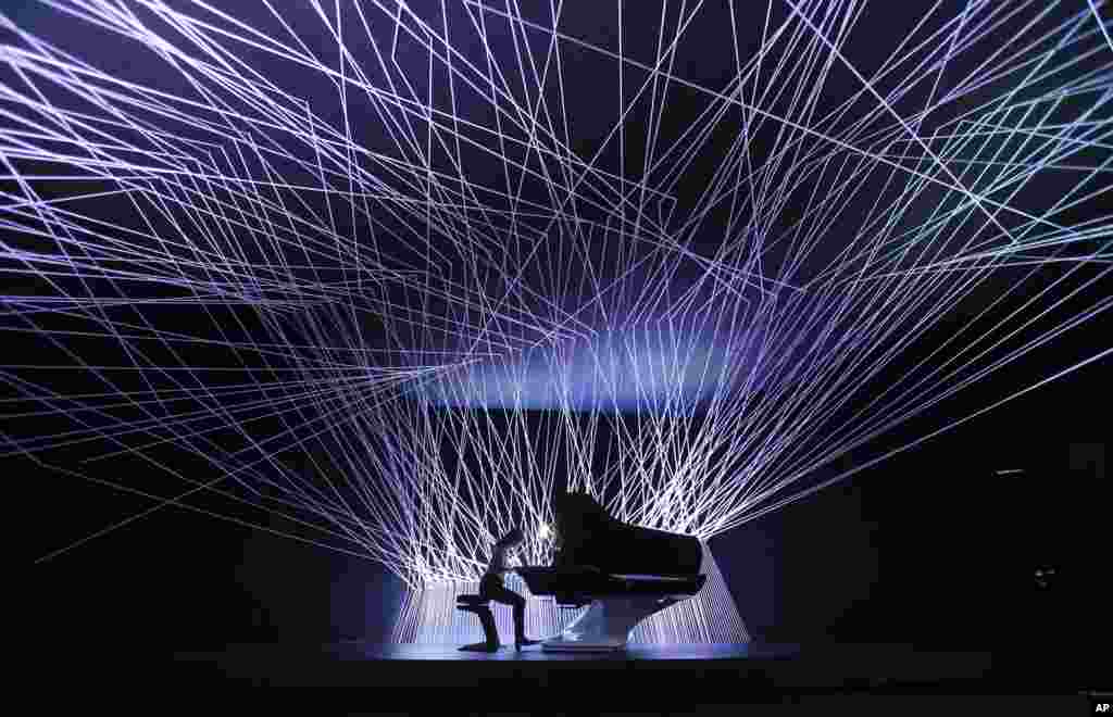 A musician plays a piano designed by car manufacturer Peugeot for Pleyel piano maker, displayed at the Milan Design Fair, in Milan, Italy, April 7, 2014.