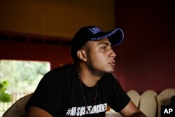 FILE - Jairo Bonilla, leader of the April 19 student movement, wears a T-shirt designed with a hashtag that reads in Spanish: "We are not criminals," during an interview in Managua, Nicaragua, July 28, 2018.