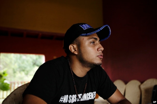 FILE - Jairo Bonilla, leader of the April 19 student movement, wears a T-shirt designed with a hashtag that reads in Spanish: "We are not criminals," during an interview in Managua, Nicaragua, July 28, 2018.