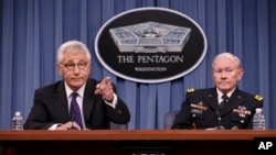 Defense Secretary Chuck Hagel, left, accompanied by Joint Chiefs Chairman Gen. Martin Dempsey brief reporters about ongoing operations against Islamic extremists in Syria and Iraq during a news conference at the Pentagon.
