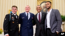 President Barack Obama poses for a photograph with Oregon National Guardsman, from left, Alek Skarlatos, Air Force Airman 1st Class Spencer Stone, and Anthony Sadler, in the Oval Office of the White House in Washington, Sept. 17, 2015.