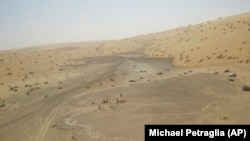 This undated photo provided by the Palaeodeserts Project in September 2021 shows the site of Khall Amayshan 4 in northern Saudi Arabia, where evidence of repeated visits by early humans over the last 400,000 years was found. The visits were connected with the remains of ancient lakes. (Michael Petraglia/Palaeodeserts Project via AP)