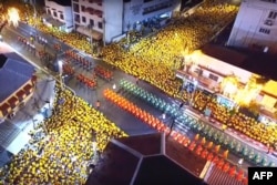 This screengrab from Thai TV Pool video taken on May 5, 2019 shows an aerial view of crowds watching the coronation procession of Thailand's King Maha Vajiralongkorn in Bangkok.