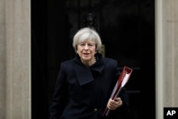 British Prime Minister Theresa May leaves 10 Downing Street in London, Feb. 1, 2017.