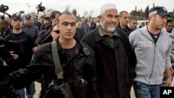 FILE - Sheik Raed Salah, the leader of the Islamic Movement in Israel, second right, is detained by Israeli policemen during an event to mark Jerusalem as the Capital of Arab Culture.