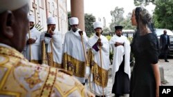 Clergy line the steps of the Holy Trinity Cathedral as White House senior adviser Ivanka Trump, right, arrives for a ceremony honoring the victims of the Ethiopian Airlines crash, Monday April 15, 2019, in Addis Ababa, Ethiopia.