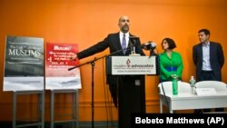 Muslim Advocates Legal Director Glenn Katon, left, and Muslim comedians Negin Farsad, center, and Dean Obeidallah, right, hold a press conference , Thursday, June 25, 2015, in New York.