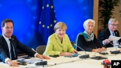From left, Dutch Prime Minister Mark Rutte, German Chancellor Angela Merkel, Managing Director of the IMF Christine Lagarde and European Commission President Jean-Claude Juncker participate in a meeting at an EU summit at the European Council building in Brussels, June 22, 2015.