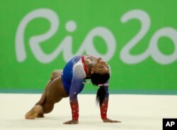 FILE - United States' Simone Biles performs on the floor during the artistic gymnastics women's apparatus final at the 2016 Summer Olympics in Rio de Janeiro, Brazil, Aug. 16, 2016.