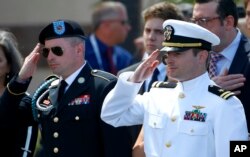 Jimmy McCain (L) and Jack McCain salute their father, Sen. John McCain, R-Ariz., after a memorial service at North Phoenix Baptist Church, Aug. 30, 2018, in Phoenix, Ariz.