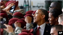 President Barack Obama and first lady Michelle Obama greet troops during a visit to Fort Bragg, N.C., Dec. 14, 2011.