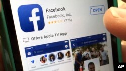 FILE - In this June 19, 2017, file photo, a user gets ready to launch Facebook app.