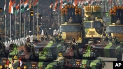 Indian army soldiers ride on T-72 tanks during the main Republic Day parade in New Delhi, January 26, 2012. 