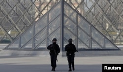 man armed with a machete and carrying two bags on his back as he tried to enter the Paris Louvre museum.
