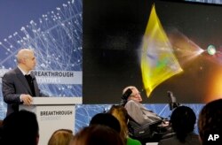 Internet investor and science philanthropist Yuri Milner, left, and renowned cosmologist Stephen Hawking, right, seated in a speech adaptive wheelchair, discuss the new Breakthrough Initiative focusing on space exploration and the search for life in the u