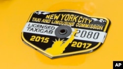 The medallion of taxi driver and taxi medallion owner Marcelino Hervias is affixed to the hood of his taxicab on New York's Upper West Side, June 26, 2017.