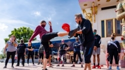 People practice MuayThai with a group of professional MuayThai instructors during a Free Self Defense Muay Thai Class, a martial art training against Asian hate crimes at Wat Thai Los Angeles, April 15, 2021.