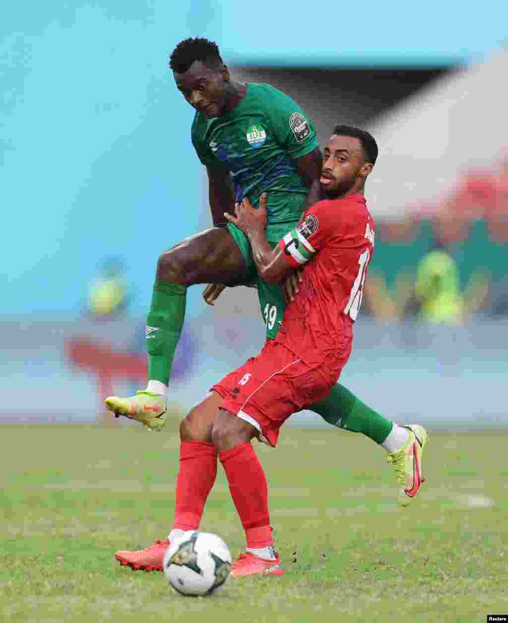 Equatorial Guinea&#39;s Carlos Akapo in action with Sierra Leone&#39;s Mustapha Bundu in Cameroon on Jan. 20, 2022.
