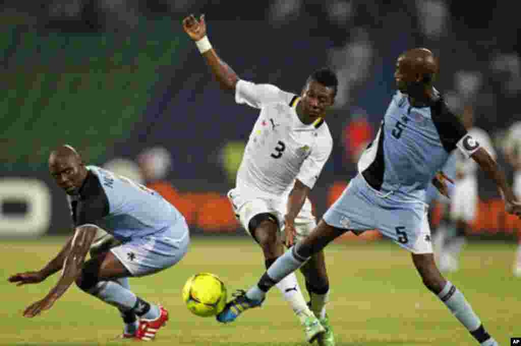 Ghana's Asamoah Gyan (C) challenges Anthony Ananan (R) and Ndiyapo Letsholathebe of Botswana during their African Cup of Nations Group D soccer match in FranceVille Stadium January 24, 2012.