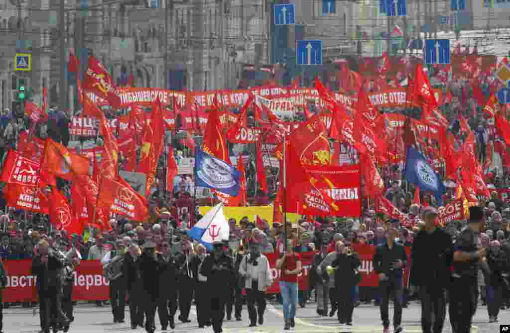 People march with red flags during a rally to mark May Day in Moscow, Russia, May 1, 2018.