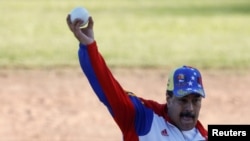 Venezuela's President Nicolas Maduro throws the ball during a softball game with ministers and military high command members at Fuerte Tiuna military base, in Caracas, Venezuela, Jan. 28, 2018.