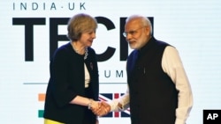 British Prime Minister Theresa May is greeted by her Indian counterpart, Narendra Modi, at the India-U.K Tech Summit in New Delhi, Nov. 7, 2016. 