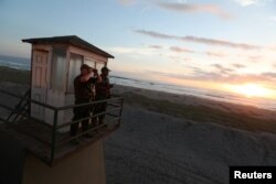 Policemen look out from a watchtower at the Chilean and Peruvian border, near Arica, Chile, Nov. 16, 2018.