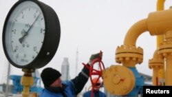 A worker turns a valve at the Nesvizhskaya gas compressor station some 130 km (81 miles) from Minsk, Jan. 9, 2009.