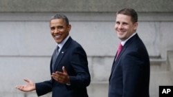 President Barack Obama and White House Senior Advisor Dan Pfeiffer, right, react to a reporter's question as they leave the Treasury Department in Washington, Jan. 16, 2013.