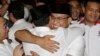 Gubernatorial candidate Anies Baswedan, center right, hugs his running mate Sandiaga Uno during a press conference in Jakarta, Indonesia, April 19, 2017. 