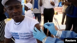 FILE - A World Health Organization (WHO) worker administers a vaccination during the launch of a campaign aimed at beating an outbreak of Ebola in Mbandaka, Democratic Republic of Congo, May 21, 2018. 