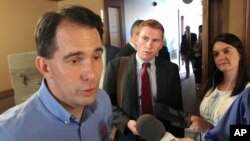 FILE - Wisconsin Gov. Scott Walker speaks to reporters in Madison, Aug. 1, 2017.