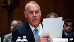 Interior Secretary Ryan Zinke arrives for a Senate Appropriations subcommittee hearing on the fiscal 2019 budget, May 10, 2018, on Capitol Hill in Washington.