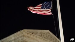 FILE - A U.S. flag flies at half-staff in front of the U.S. Supreme Court in Washington, Feb. 13, 2016.