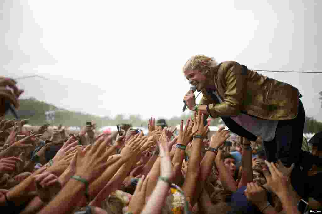 Vocalist Christian Zucconi of the Grouplove band greets fans during a performance at the Firefly Music Festival in Dover, Delaware, USA, June 21, 2014. The four-day festival is set at the 105-acre grounds on the Dover International Speedway where many well known bands will perform.