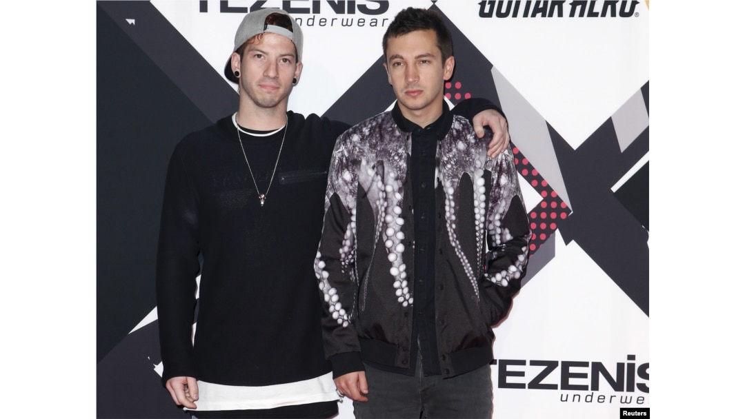 FILE - Twenty One Pilots pose on the red carpet during the MTV EMA awards at the Assago forum in Milan, Italy.