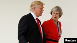 FILE - U.S. President Donald Trump escorts British Prime Minister Theresa May after their meeting at the White House in Washington.