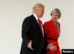 FILE - U.S. President Donald Trump escorts British Prime Minister Theresa May after their meeting at the White House in Washington, Jan. 27, 2017.