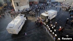 Demonstrators try to stop an armored police vehicle during a protest at Taksim Square in central Istanbul, Turkey, July 6, 2013.