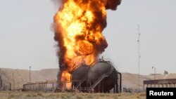 Smoke rises after an attack at Bai Hassan oil station, northwest of Kirkuk, Iraq, July 31, 2016.