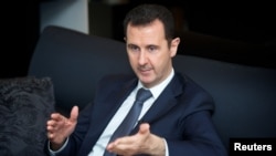 Syrian President Bashar al-Assad gestures during an interview in Damascus in this handout photo distributed by Syria's national news agency SANA on September 2, 2013.
